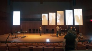 During an early rehearsal of A Pierre Dream, technicians work with the banners and projected images.