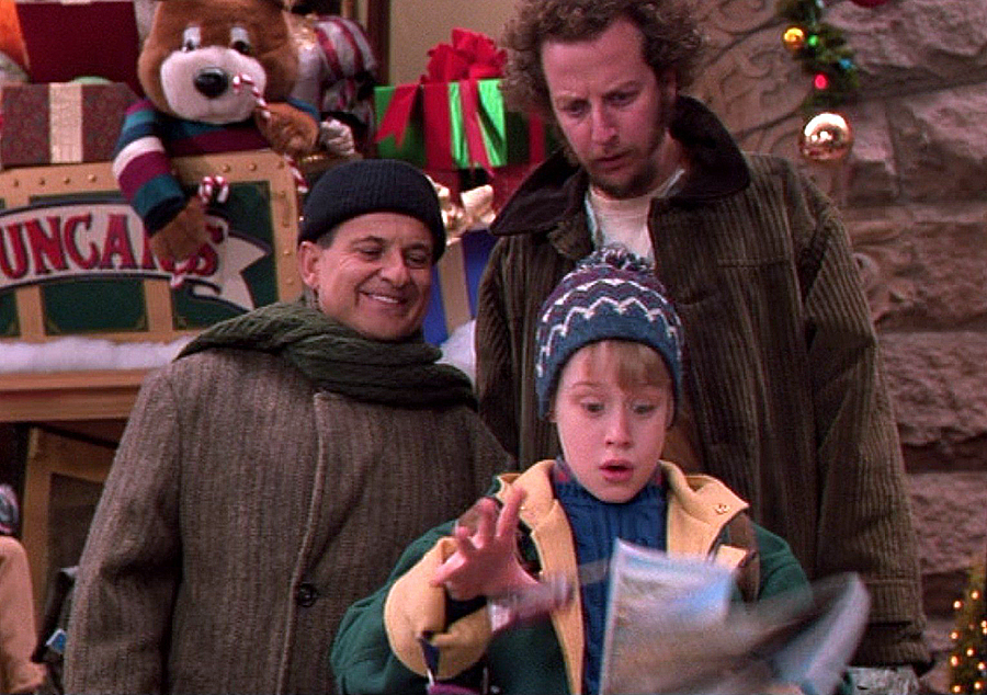 Kevin (Macauley Culkin) is menaced by the bumbling bandits Harry (Joe Pesci, left) and Marv (Daniel Stern) in "Home Alone."