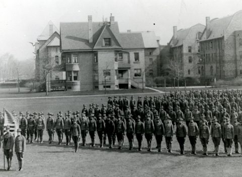 Photograph of a SATC drill, 1918. Taken on Northwestern’s Evanston campus; Fraternity North Quad in the background.